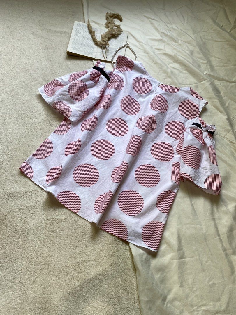 White and Red Polka Dot Cold Shoulder Top Large 40 (Category: Blouses) located in Poro. Submitted by joyceyuu (Listing ID 1461303429, Image 3). Description: - White top with large red polka dots - Cold shoulder sleeves with black ribbon detail - Flared sleeves - Estimated size: Medium - Ideal for casual outings.
