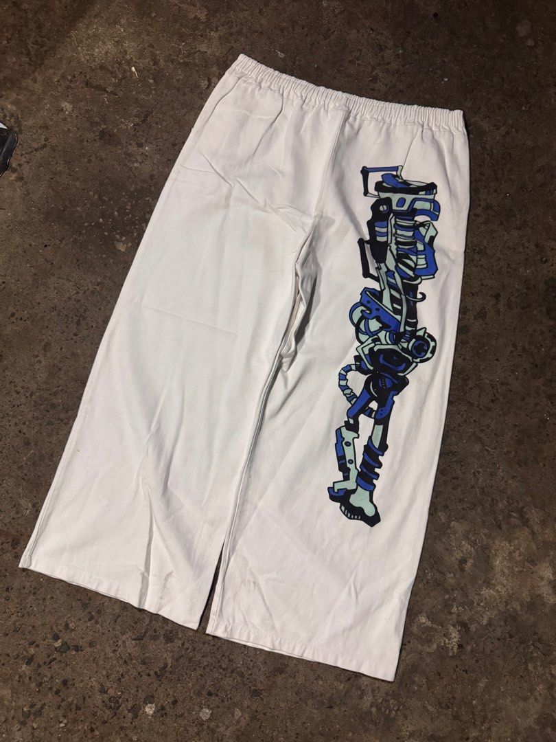 White Anime Graphic Wide Leg Pants (Category: Other Bottoms) located in Pasig City. Submitted by dripthrift1600 (Listing ID 1461258701, Image 2). Description: - Trendy white pants with eye-catching anime graphics. - One leg features a full-body character design. - The other leg showcases a cool mechanical design. - Comfortable elastic waistband for a perfect fit. - Stylish wide-leg silhouette. - Ideal for casual outings or making a bold fashion s
