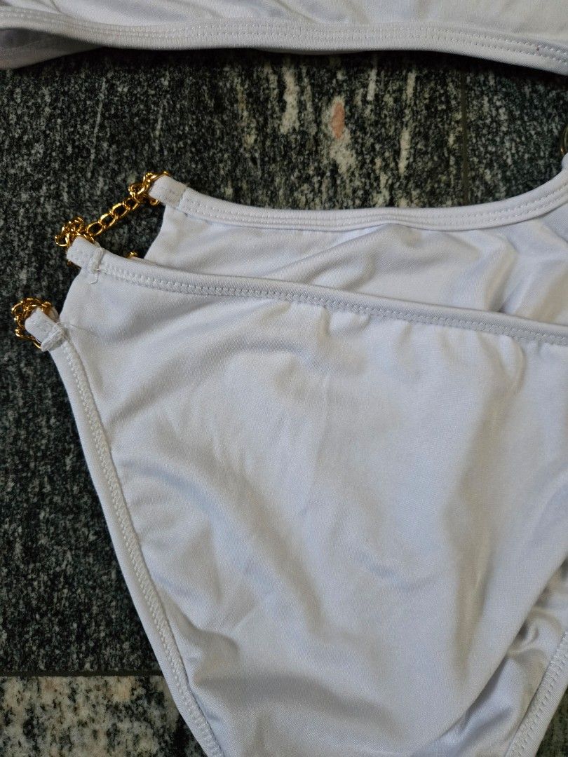 White Bikini Set with Gold Chain Detail (Category: Bikinis & Swimsuits) located in Las Pinas. Submitted by juliagarcia95 (Listing ID 1461169543, Image 3). Description: - Stylish white bikini set - Features elegant gold chain accents on straps - Halter neck top design - Flattering high-waisted bottom - Made with stretchy material for comfort - Ideal for beach trips and pool days.
