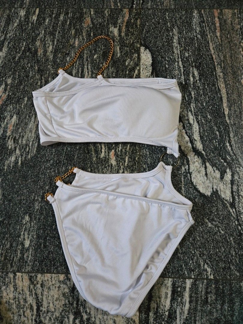 White Bikini Set with Gold Chain Detail (Category: Bikinis & Swimsuits) located in Las Pinas. Submitted by juliagarcia95 (Listing ID 1461169543, Image 1). Description: - Stylish white bikini set - Features elegant gold chain accents on straps - Halter neck top design - Flattering high-waisted bottom - Made with stretchy material for comfort - Ideal for beach trips and pool days.