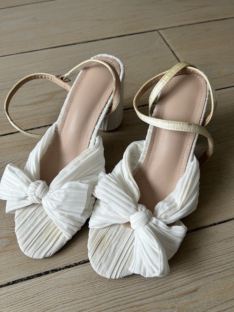 White Bow Block Heels with Ankle Strap (Category: Heels) located in Paranaque City. Submitted by nicolelagleva (Listing ID 1461128273, Image 1). Description: - White sandals with a cute bow detail - Features a comfortable block heel - Secure ankle strap for support - Textured fabric for a stylish look - Size 38 - used for my beach wedding only.