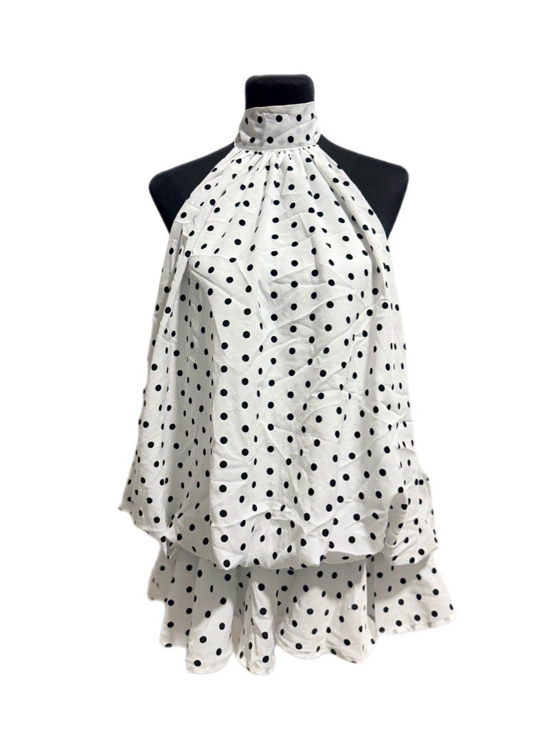 White Polka Dot Halter Neck Top (Category: Sleeveless) located in Trece Martires City. Submitted by raresen26 (Listing ID 1461279447, Image 1). Description: - Cute white top with black polka dots - Halter neck design - Gathered neckline - Layered hemline for added flair - Versatile: pairs well with shorts or jeans - Ideal for casual outings or nights with friends.