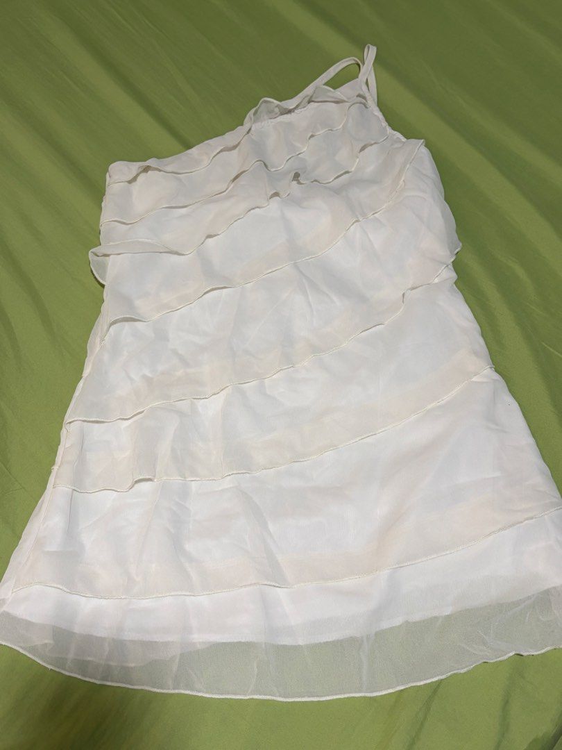 White Ruffled One-Shoulder Dress (Category: Dresses) located in Nagcarlan. Submitted by bye20s (Listing ID 1461225579, Image 2). Description: Never worn. Wrong size for me 😅 - White dress with all-over ruffles - Chic one-shoulder design - Features a sheer overlay fabric - Ideal for parties or a night out - Cute and flirty style.