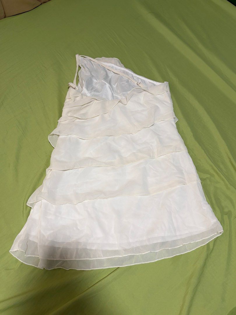 White Ruffled One-Shoulder Dress (Category: Dresses) located in Nagcarlan. Submitted by bye20s (Listing ID 1461225579, Image 3). Description: Never worn. Wrong size for me 😅 - White dress with all-over ruffles - Chic one-shoulder design - Features a sheer overlay fabric - Ideal for parties or a night out - Cute and flirty style.