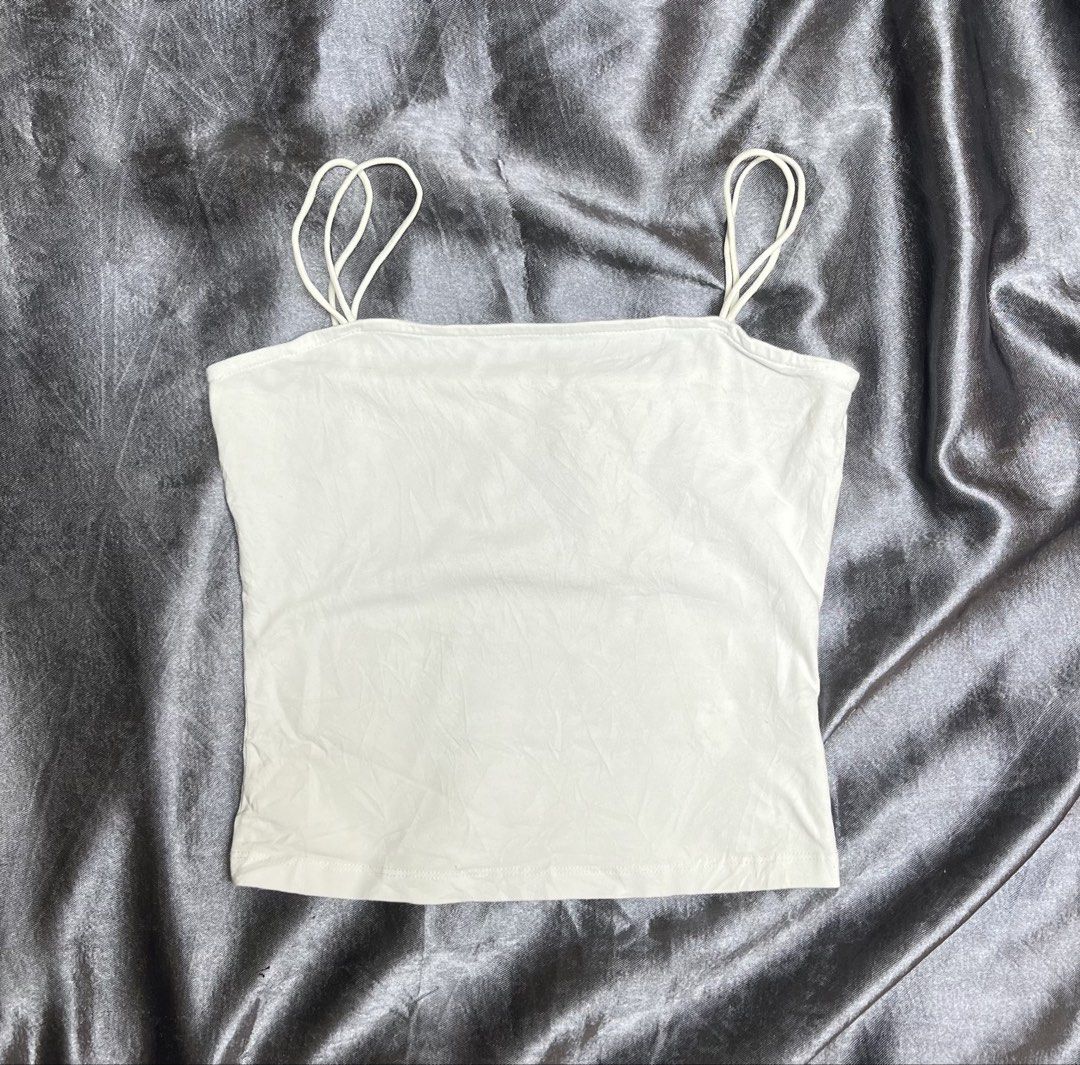 White Spaghetti Strap Tank Top (Category: Sleeveless) located in Cavite. Submitted by bellewii (Listing ID 1461234125, Image 1). Description: - Basic white tank top - Thin spaghetti straps - Soft and stretchy material - Versatile for layering or wearing alone - Ideal for casual wear or as a base layer.