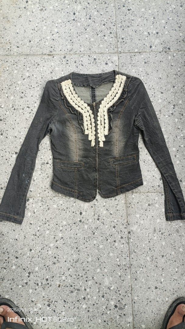 Women's Grey Denim Jacket with Lace Collar (Category: Coats, Jackets and Outerwear) located in Manila. Submitted by treblig. (Listing ID 1461240121, Image 1). Description: - Grey denim jacket - Long sleeves - Unique lace trim around the neckline - Front zipper closure - Two chest pockets - Split hem back with zipper - Ideal for layering - Pairs well with jeans or skirts.