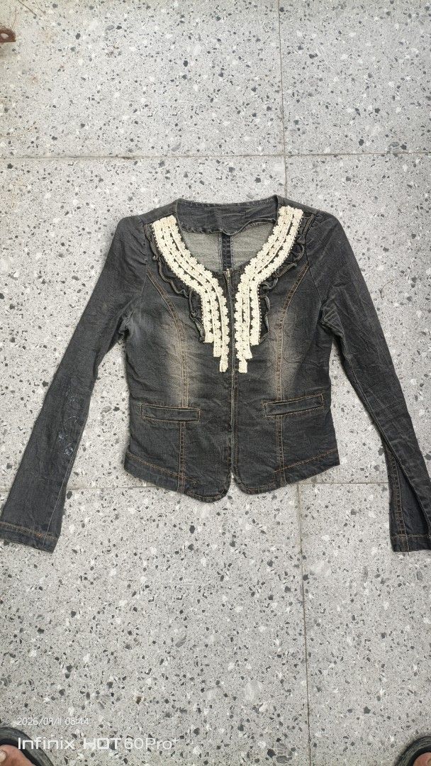 Women's Grey Denim Jacket with Lace Collar (Category: Coats, Jackets and Outerwear) located in Manila. Submitted by treblig. (Listing ID 1461240121, Image 3). Description: - Grey denim jacket - Long sleeves - Unique lace trim around the neckline - Front zipper closure - Two chest pockets - Split hem back with zipper - Ideal for layering - Pairs well with jeans or skirts.