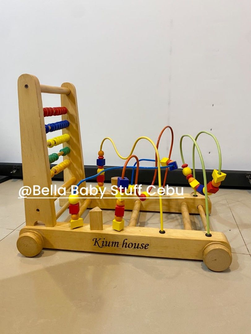 Wooden Baby Learning Push Walker (Category: Infant Playtime) located in Cebu City. Submitted by bellababystuffcebu (Listing ID 1461255280, Image 2). Description: Wooden Baby Learning Push Walker Preloved in Very Good Condition Works as a push toy to help toddlers practice walking and as a stationary activity center. Features curved metal wires with colorful wooden shapes and beads for motor skill practice. Please see video for reference https://f
