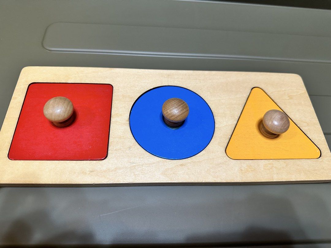 Wooden Shape Sorter Puzzle - Triangle, Circle, Square (Category: Educational & Learning Toys) located in Manila. Submitted by silver.truemountain (Listing ID 1461245027, Image 1). Description: - Classic wooden shape sorter toy. - Includes red square, blue circle, and orange triangle. - Features easy-to-grip wooden knobs for little hands. - Perfect for teaching shapes and colors. - Made with sturdy, durable wood construction. - A fun and education