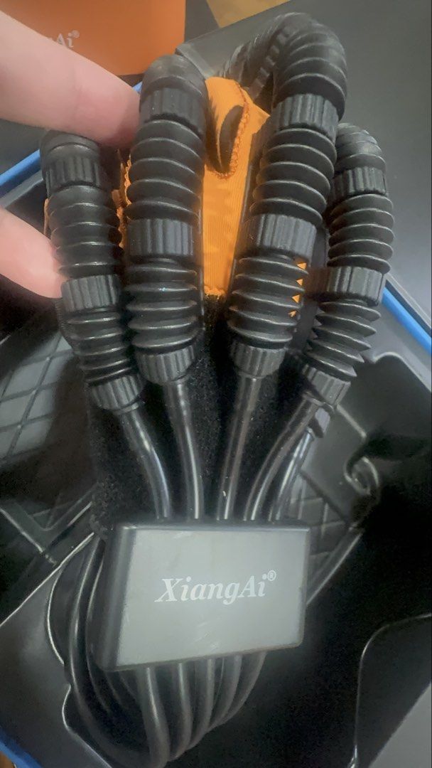 XiangAi Robot Training Glove (Category: Medical Supplies & Tools) located in Quezon City. Submitted by nhamaq (Listing ID 1461248814, Image 3). Description: - XiangAi Robot Training Glove set (LEFT HAND) - Includes: Glove with flexible finger tubing, control unit with buttons and display, small orange ball - All items are in the original box - Ideal for rehabilitation or training purposes.