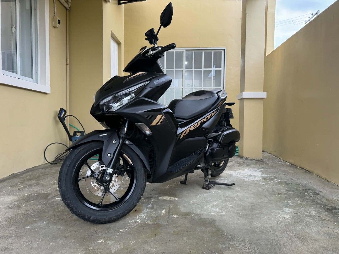 Yamaha Aerox V2 ABS 155 VVA Keyless (Category: Motorbikes for Sale) located in Manila. Submitted by yadordioni08067 (Listing ID 1461319569, Image 2). Description: FOR SALE AEROX V2 ABS 155 VVA (Keyless) 1st owner 📍2021 model 📍2K+ orig odo (low mileage/seldom used) 📍original lto plate 📍complete orig papers 📍all stock 📍issue unregistered/minimal scratches 📍95K PHP Cabanatuan City Location Matte black finish with gold accents. Low mileage and