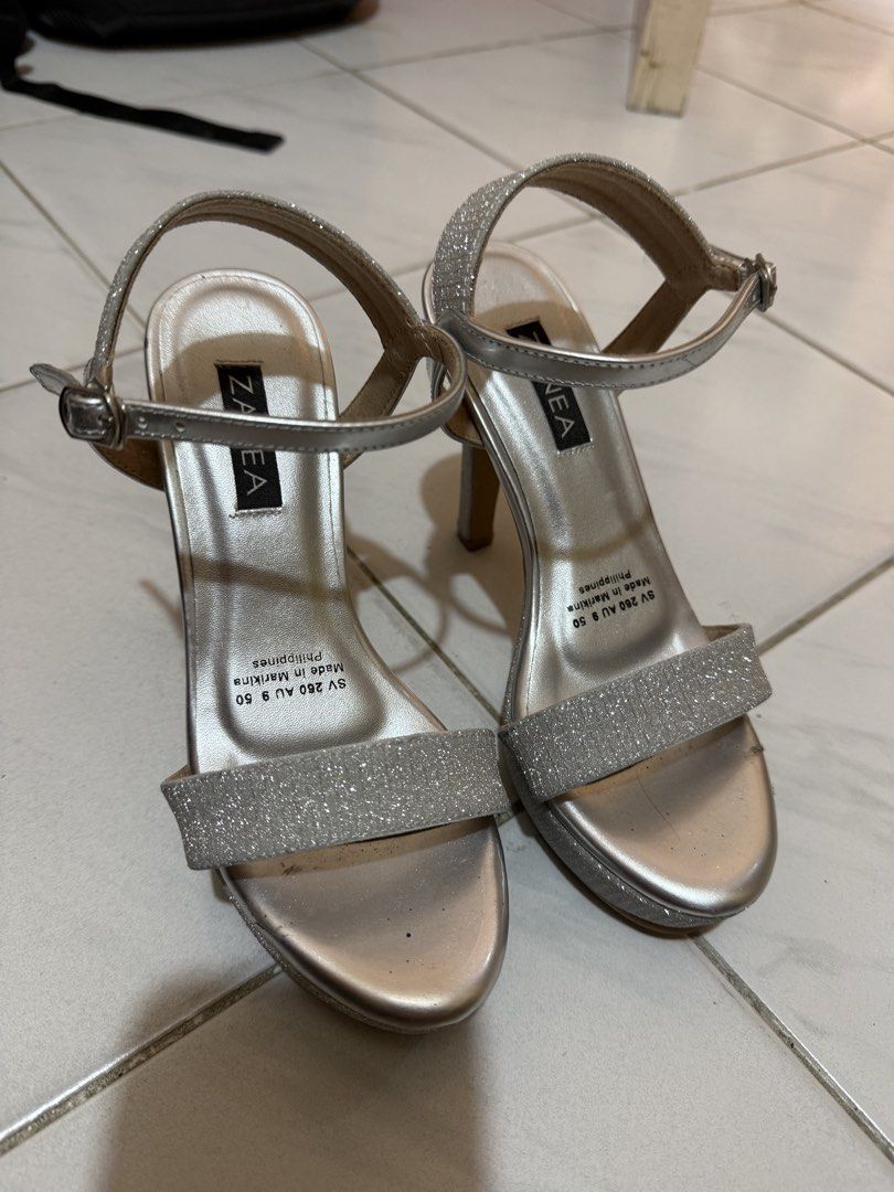 Zanea Silver Flitter Heels (Category: Heels) located in Lipa City. Submitted by myworldstuff (Listing ID 1461324106, Image 2). Description: Worn only once and still in very good condition. Sparkly silver design with a simple, elegant style perfect for parties, formal events, graduations, or special occasions. 📌 Condition: Worn once / lightly used 📌 Color: Silver glitter 📌 Style: Strappy heels 📌 Brand: Zanea 📌 Size: 5.