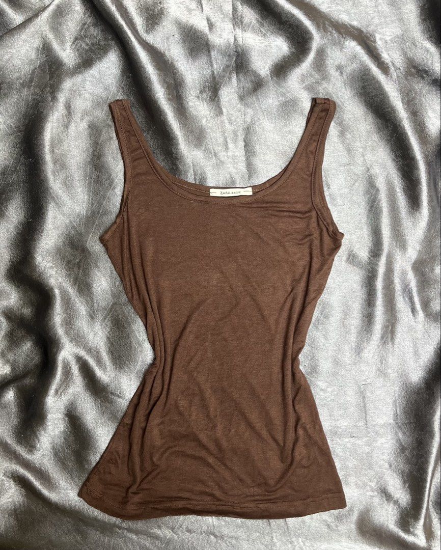 Zara Basic Brown Tank Top (Category: Sleeveless) located in Cavite. Submitted by bellewii (Listing ID 1461226036, Image 1). Description: - Basic brown tank top from Zara - Simple and versatile design - Soft fabric for comfort - Snug, flattering fit - Ideal for layering or wearing on its own.