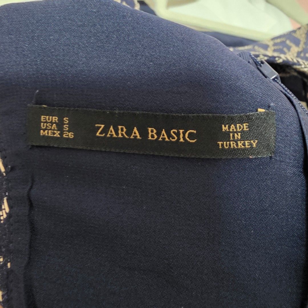 Zara Basic Navy Blue Patterned Dress Size S (Category: Dresses) located in Mandaluyong City. Submitted by Llyssa12 (Listing ID 1461249158, Image 3). Description: - Navy blue dress with a light beige pattern - Sleeveless design - Zipper closure at the side - Versatile for casual outings or dressing up -Shipping is shouldered by the buyer - Size: Small.