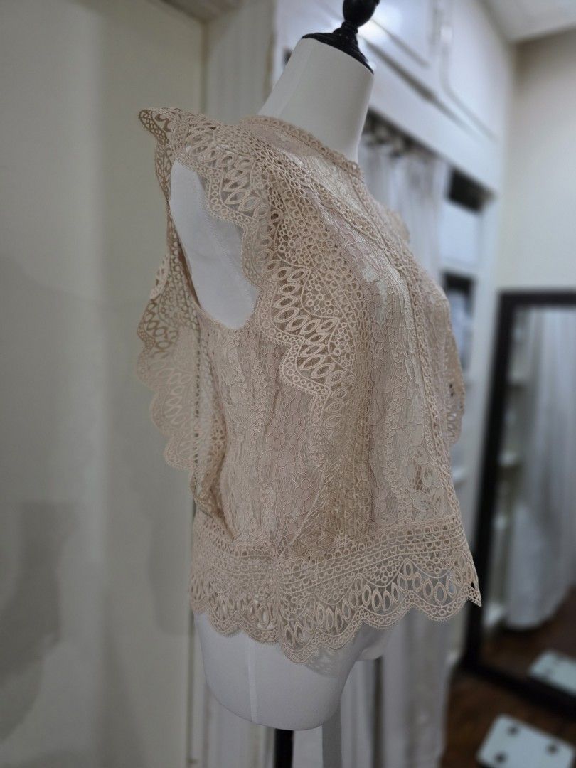 Zara Lace Top - Size M (Category: Sleeveless) located in Quezon City. Submitted by sec0nd.st0ry (Listing ID 1461226683, Image 2). Description: - Zara lace top - Color: Light pinkish-beige - Size: Medium - Features intricate lace detailing all over - High neckline with scalloped edges - Versatile: perfect for layering or wearing on its own - Ideal for night outs or special occasions.