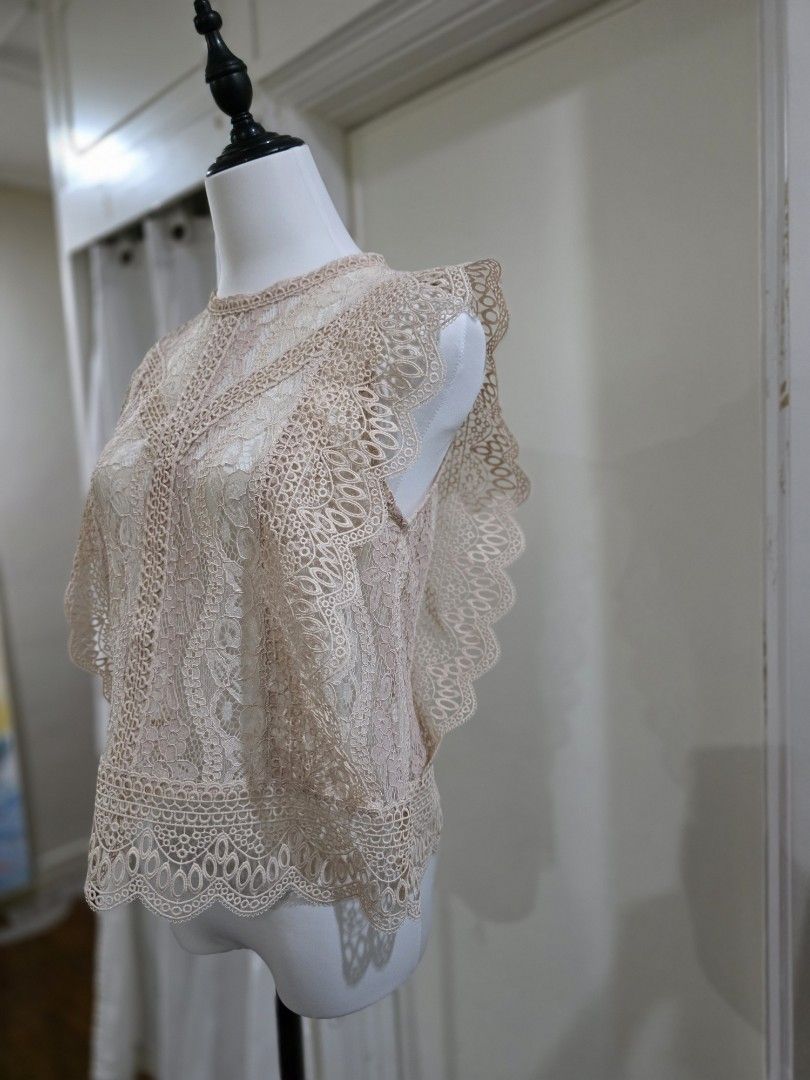 Zara Lace Top - Size M (Category: Sleeveless) located in Quezon City. Submitted by sec0nd.st0ry (Listing ID 1461226683, Image 3). Description: - Zara lace top - Color: Light pinkish-beige - Size: Medium - Features intricate lace detailing all over - High neckline with scalloped edges - Versatile: perfect for layering or wearing on its own - Ideal for night outs or special occasions.