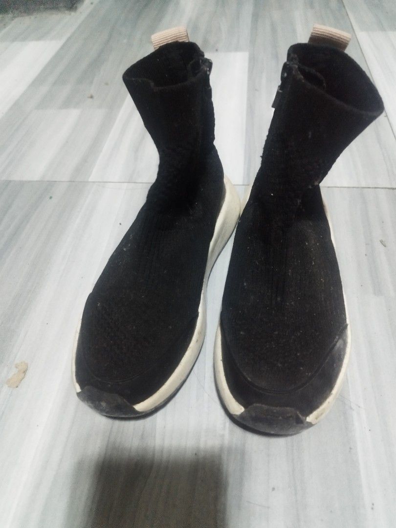 Zara shoes for kids (Category: Babies & Kids Fashion) located in Manila. Submitted by Mayo.T (Listing ID 1461320147, Image 2). Description: - Black sock-style sneakers - Side zipper closure - White rubber soles with brown heel accent - Minor scuffing on soles and fabric - Perfect for everyday wear - needs cleaning .
