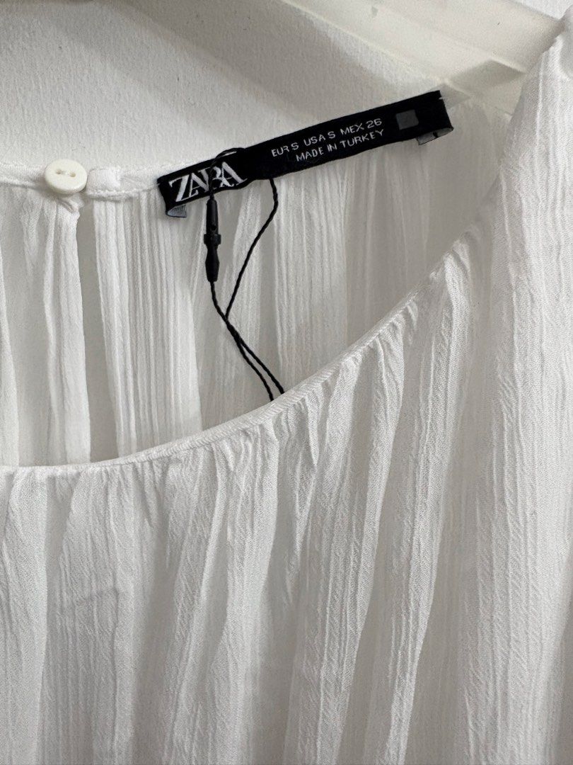 ZARA White Cut-out Maxi Dress (Category: Dresses) located in Quezon City. Submitted by thebutingthings (Listing ID 1461277019, Image 2). Description: - ZARA White Maxi Dress - Features stylish cut-outs at the waist - Short sleeves and a flowy skirt for a breezy feel - Convenient button closure at the back - Proudly made in Turkey - Ideal for beach vacations or summer outings.
