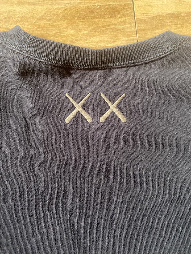 2 KAWS X UNIQLO SWEATSHIRT PULLOVER SWEATER (Category: Coats, Jackets and Outerwear) located in Dagupan City. Submitted by well.layed (Listing ID 1461558686, Image 3). Description: black w24 x l27 check pics for condition white offwhite w23 x l27 check pics for condition unnoticeable neck stains stretched collar.