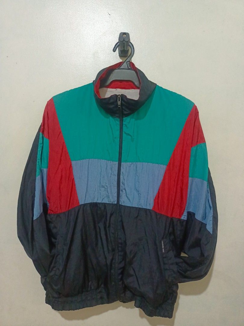 80's vintage members only Jacket (Category: Coats, Jackets and Outerwear) located in Cavite. Submitted by kjthriftlabcorner (Listing ID 1461559974, Image 3). Description: - Style: Color-block windbreaker / racer jacket — black top with bold panels of red, light blue, teal/green below ​ - Fabric: Lightweight nylon — typical for windbreakers ​ - Details: Full zip, elastic cuffs/waistband, soft inner lining ​ - Vibe: Retro 80s/90s sporty, vintage st