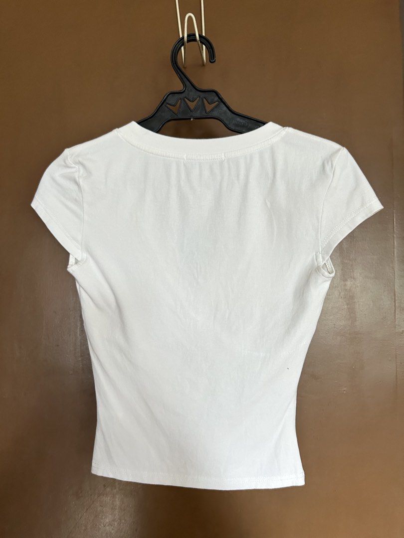 90s Inspired V Neck White Top (Category: Shirts) located in Manila. Submitted by anothermanxtreasure (Listing ID 1461398871, Image 2). Description: Good for a capsule wardrobe Cute cap sleeve detail, dainty + sexy Reminds me of Carolyn Bessette Has a small brown stain on the side (zoom in).