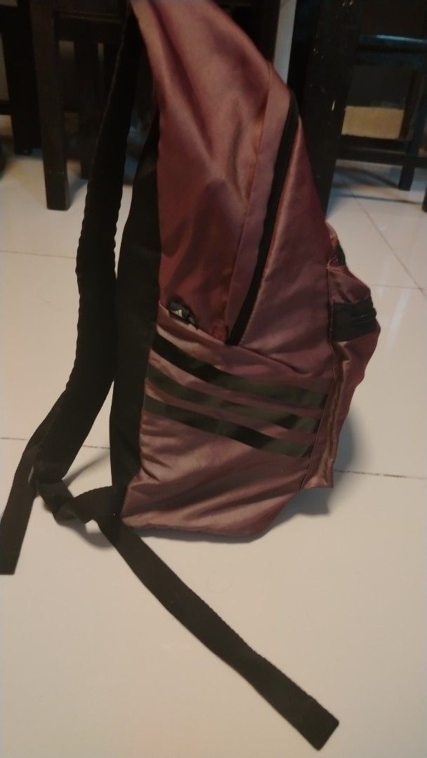 Adidas Backpack - Purple/Maroon (Category: Backpacks) located in Manila. Submitted by wildwind_73f77a (Listing ID 1461492898, Image 3). Description: - Shiny purple or maroon Adidas backpack - Front zip pocket and main compartment - Classic Adidas stripes on the side - Padded straps for comfortable carrying - Ideal for school or everyday use.