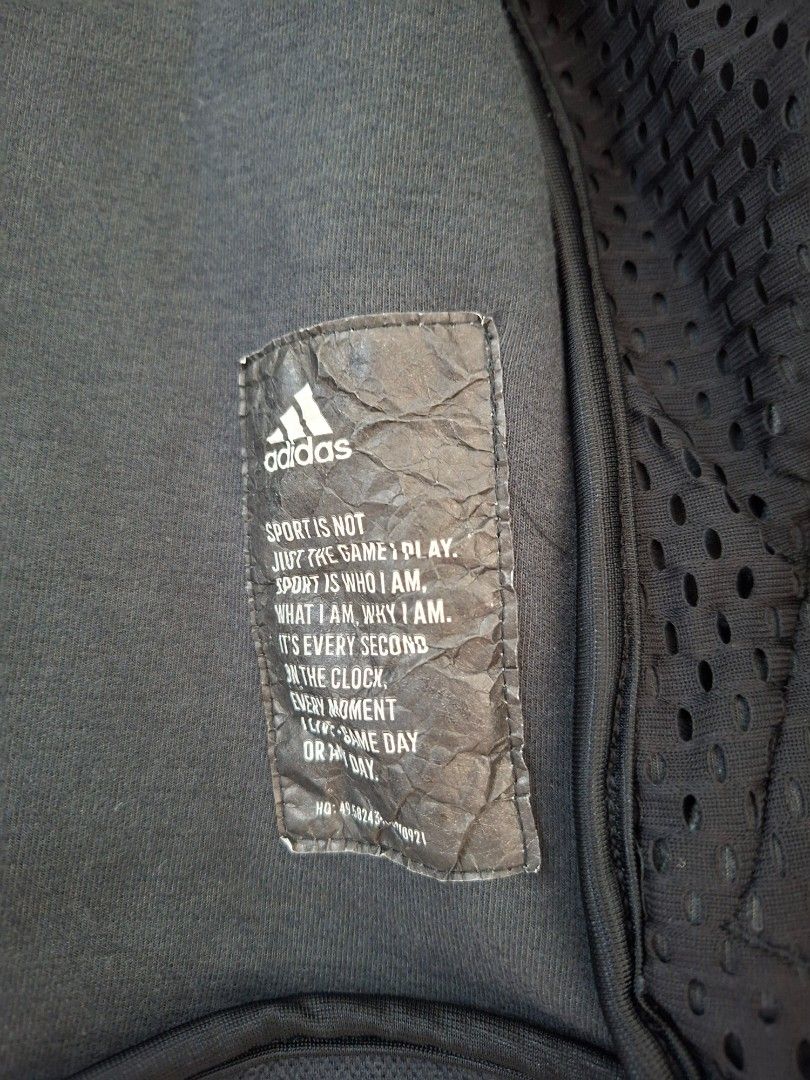 Adidas Black Zip-Up Hoodie (Category: Coats, Jackets and Outerwear) located in Pasig City. Submitted by avcan (Listing ID 1461396295, Image 2). Description: - Black Adidas zip-up hoodie - Features mesh detail inside - Tag quote: 'Sport is not just the game, play. Sport is who I am.' - Size: S - Made in Vietnam - Perfect for casual wear or sports activities.