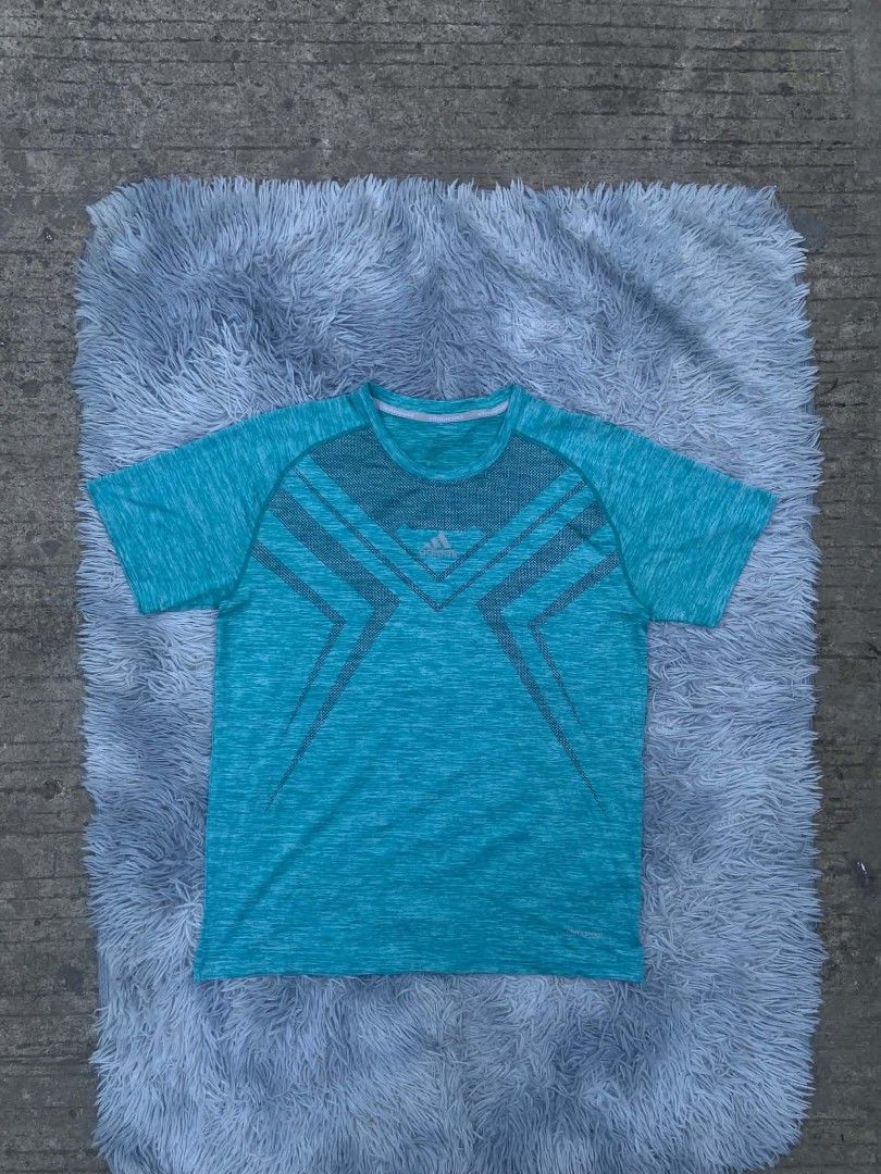 Adidas ClimaCool Teal T-shirt (Category: Tshirts & Polo Shirts ) located in Lianga. Submitted by arwthrifts (Listing ID 1461468351, Image 1). Description: - Teal Adidas t-shirt - ClimaCool technology for breathability - Heathered texture - Geometric pattern on front - Short sleeves - Crew neck - Ideal for workouts or casual wear - Comfortable and breathable fabric.