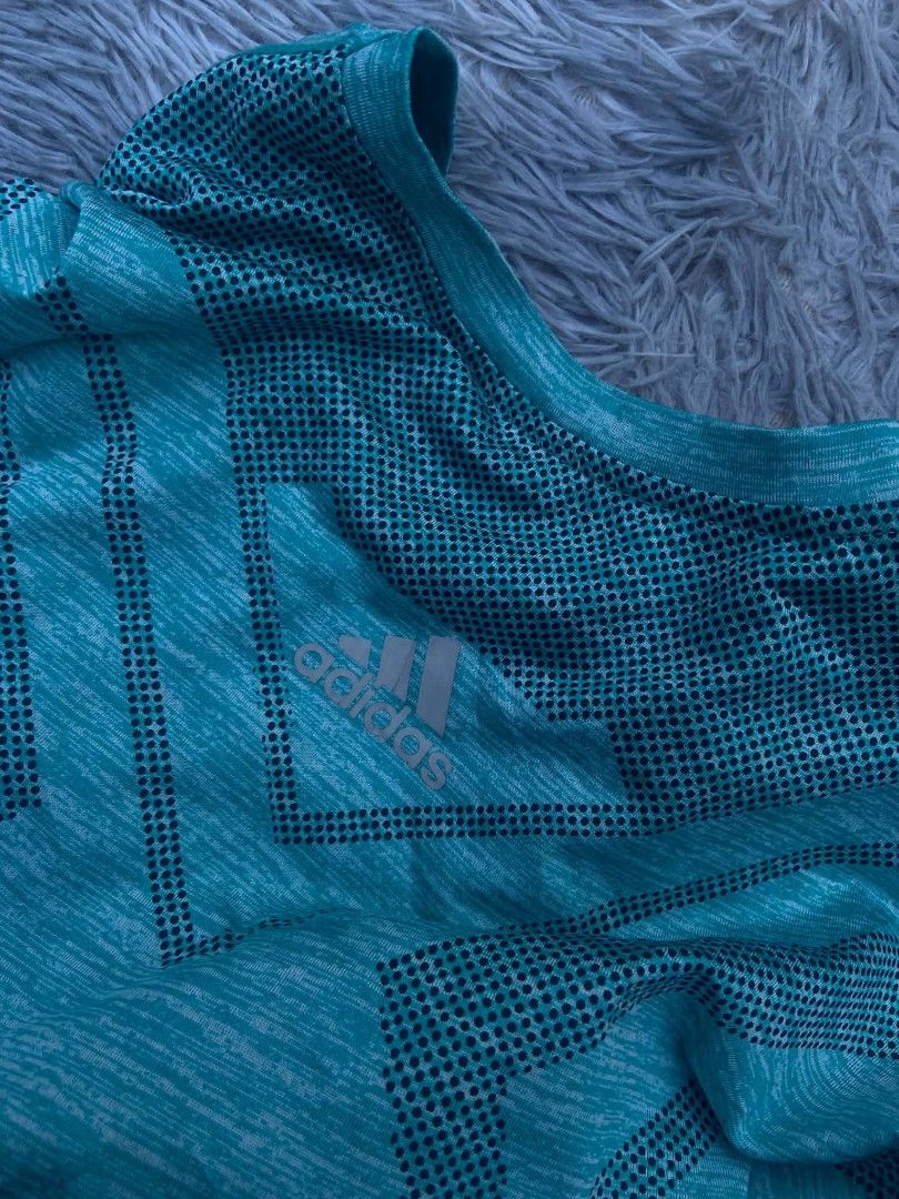 Adidas ClimaCool Teal T-shirt (Category: Tshirts & Polo Shirts ) located in Lianga. Submitted by arwthrifts (Listing ID 1461468351, Image 3). Description: - Teal Adidas t-shirt - ClimaCool technology for breathability - Heathered texture - Geometric pattern on front - Short sleeves - Crew neck - Ideal for workouts or casual wear - Comfortable and breathable fabric.