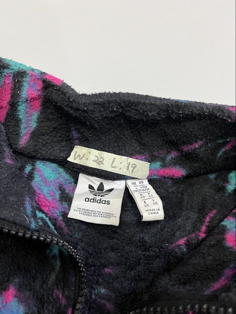 Adidas Fleece Pullover Jacket Multi-Color Print (Category: Coats, Jackets and Outerwear) located in Mabalacat. Submitted by aas_thriftfings (Listing ID 1461492915, Image 3). Description: - Cool Adidas fleece pullover - Black base with vibrant pink and teal abstract print - Quarter zip neckline - Cropped fit - 100% polyester material - Perfect for layering or as a standalone piece - Check tags for sizing details.