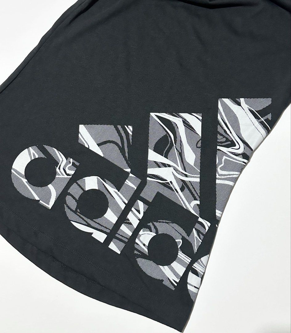 Adidas Performance T-Shirt (Category: Activewear) located in Manila. Submitted by reclaimed.shop (Listing ID 1461360595, Image 2). Description: Description: Designed for training and active lifestyles, this adidas women’s performance tee combines a fitted athletic silhouette with a bold, eye-catching graphic. Featuring a jet black matte finish and an oversized adidas graphic with a dynamic marble-inspired pattern, it offers a sporty look while ke
