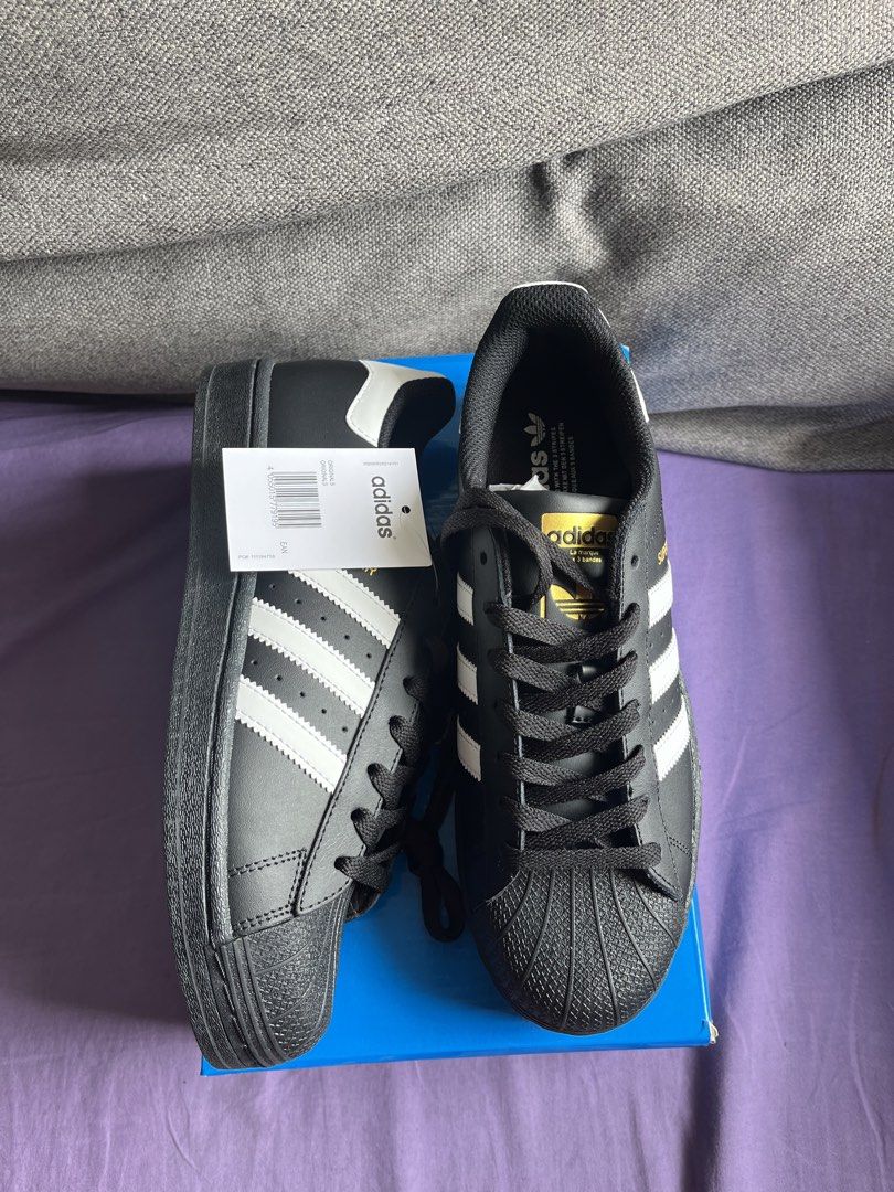 Adidas Superstar (Top grade) (Category: Sneakers) located in Manila. Submitted by gelfaves (Listing ID 1461415416, Image 1). Description: - Classic Adidas Superstar sneakers - Color: Black with white stripes - Iconic shell toe design - Ideal for everyday wear - Comes with original box - Made in Indonesia - Size: UK 8 / EU 41 / JPN 260 TOP GRADE .