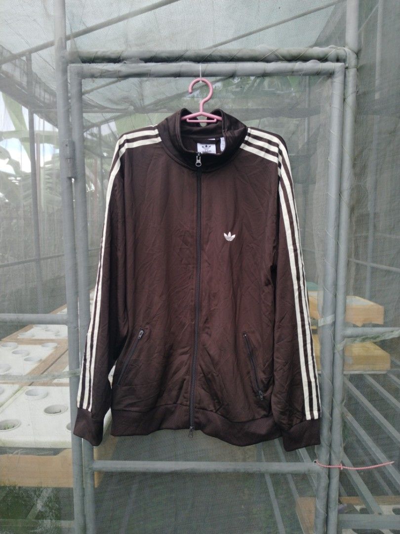 Adidas Track Jacket (Category: Coats, Jackets and Outerwear) located in Legazpi City. Submitted by genobecollectives (Listing ID 1461422076, Image 1). Description: Adidas track jacket 800 + sf - White stripes on sleeves - Full zip closure - Two zippered front pockets - Iconic Adidas logo on chest - Ideal for casual wear or athletic activities -excellent condition -23 x 28.
