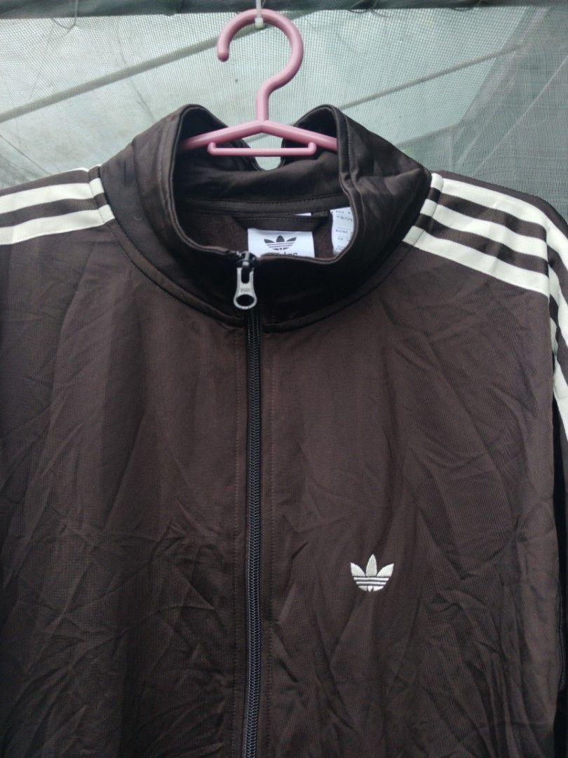 Adidas Track Jacket (Category: Coats, Jackets and Outerwear) located in Legazpi City. Submitted by genobecollectives (Listing ID 1461422076, Image 2). Description: Adidas track jacket 800 + sf - White stripes on sleeves - Full zip closure - Two zippered front pockets - Iconic Adidas logo on chest - Ideal for casual wear or athletic activities -excellent condition -23 x 28.