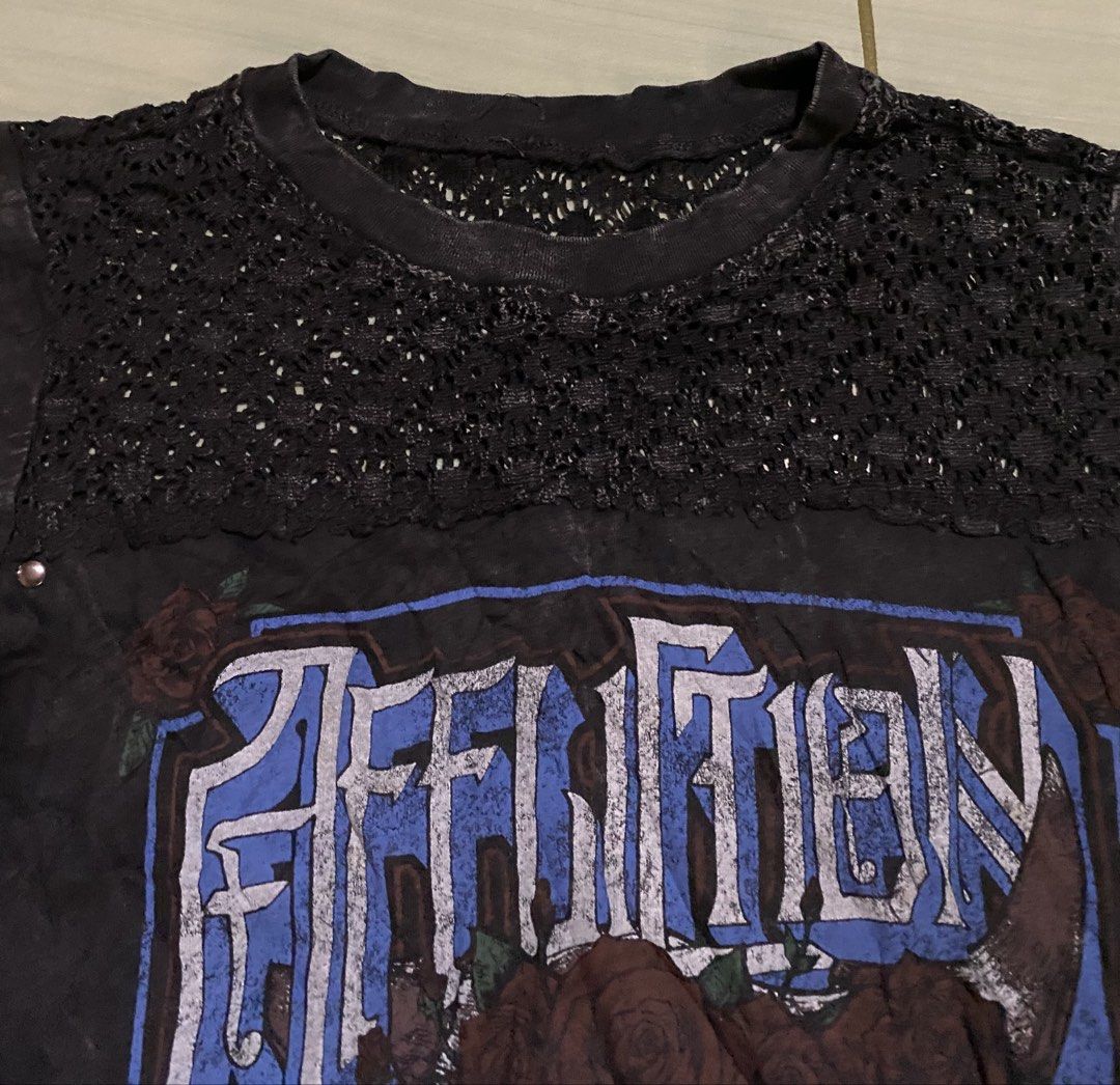 Affliction American Customs T-shirt (Category: Shirts) located in San Carlos City. Submitted by roseee_012 (Listing ID 1461468954, Image 3). Description: - Brand: Affliction - Color: Black - Size: Medium (M) - Design: Cool skull and roses graphic - Details: Lace trim around neckline, studded accents on sides - Material: 100% Cotton - Style: Ideal for a rock or biker aesthetic.