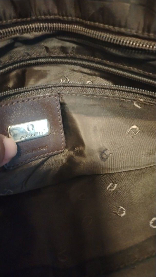 Aigner Monogram Tote Bag Brown (Category: Luxury Bags & Wallets) located in Manila. Submitted by wildwind_73f77a (Listing ID 1461503923, Image 2). Description: - Authentic brown Aigner tote bag - All-over signature monogram pattern - Elegant gold hardware details on straps - Spacious interior with multiple compartments - Includes a secure zip pocket - Expertly crafted in Italy - Ideal for carrying daily essentials.