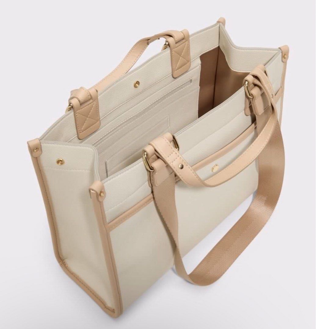 Adalimax Satchel Bag (Category: Tote Bags) located in Paranaque City. Submitted by 1tsmerach (Listing ID 1461353233, Image 2). Description: - Cream tote bag with elegant tan trim. - Features a convenient detachable shoulder strap. - Interior pockets for organized storage. - Ideal for everyday use or travel. - Clean and simple design, perfect for your essentials. Handle drop length 5” Height 15.5” Width 14” Depth 5.5”.