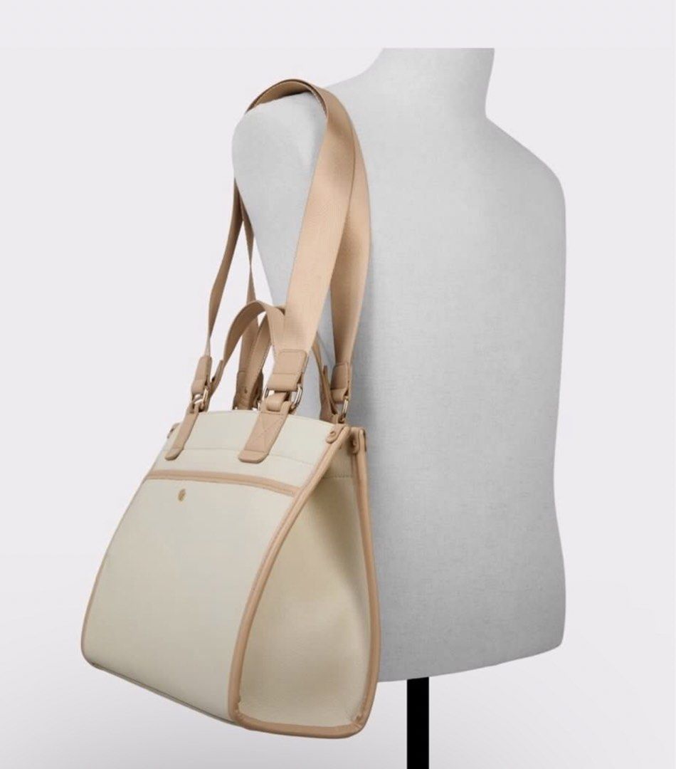 Adalimax Satchel Bag (Category: Tote Bags) located in Paranaque City. Submitted by 1tsmerach (Listing ID 1461353233, Image 3). Description: - Cream tote bag with elegant tan trim. - Features a convenient detachable shoulder strap. - Interior pockets for organized storage. - Ideal for everyday use or travel. - Clean and simple design, perfect for your essentials. Handle drop length 5” Height 15.5” Width 14” Depth 5.5”.