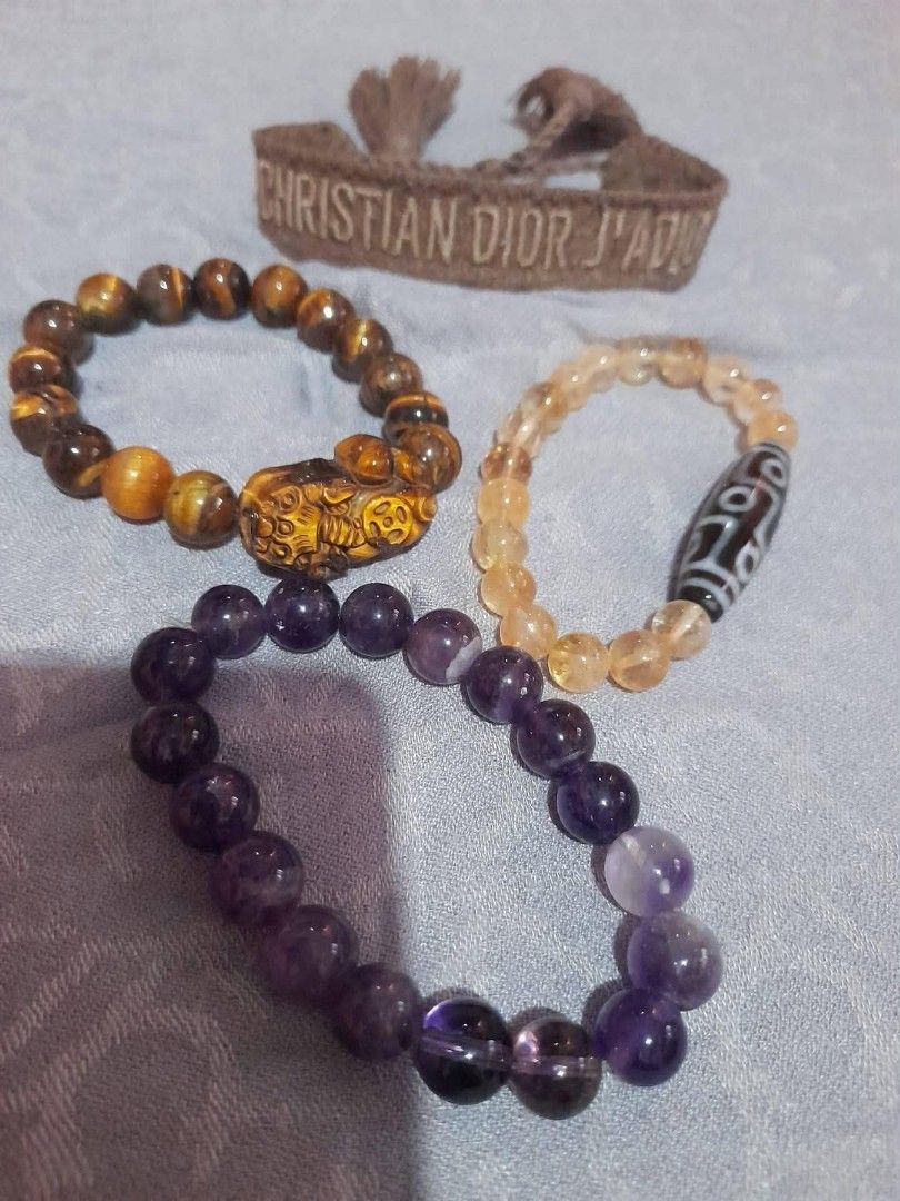 Amethyst, Tiger Eye, Citrine & Dzi Bead Bracelets (Category: Bracelets) located in General Trias. Submitted by newberg0211 (Listing ID 1461327874, Image 1). Description: - Set of 4 bracelets - Beaded Bracelet 1: Purple Amethyst with Clear Quartz accent - Beaded Bracelet 2: Tiger Eye with carved Dragon charm - Beaded Bracelet 3: Yellow Citrine with Dzi bead - Includes c Christian Dior J'Adior bracelet - Ideal for layering or as individual statemen