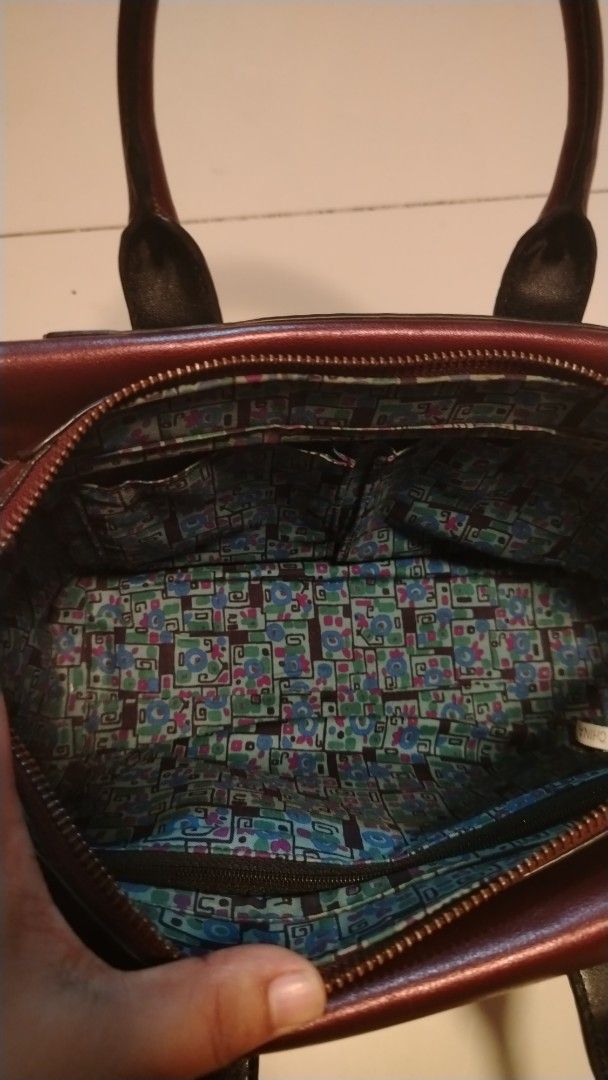 ANNA SUI Burgundy Leather Top Handle Bag (Category: Purses & Pouches) located in Manila. Submitted by wildwind_73f77a (Listing ID 1461503506, Image 3). Description: - Authentic ANNA SUI burgundy leather handbag - Unique patterned interior lining - Secure zipper closure - Two comfortable top handles - Protective metal studs on the bottom - Versatile for everyday or special occasions.
