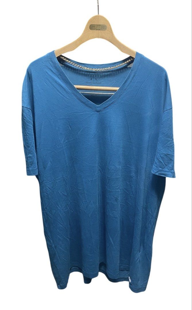 Armani Exchange Blue V-Neck Shirt (Category: Tshirts & Polo Shirts ) located in San Pedro. Submitted by lifebeginsaftercoff33 (Listing ID 1461478918, Image 2). Description: - Brand: Armani Exchange - Color: Blue - Neckline: V-neck - Material: 100% Pima Cotton - Size: XL - Dimes: 24 x 30 in - Style: Casual wear - Features: Soft and comfortable stretchy fabric - Condition: Please check photos for details - Made in Peru - RN#103723.