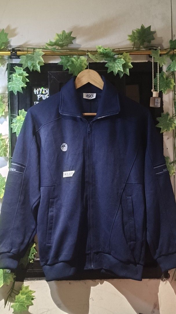 Asics Navy Blue Track Jacket (Category: Coats, Jackets and Outerwear) located in Manila. Submitted by moneyroll420 (Listing ID 1461472160, Image 1). Description: - Navy blue Asics track jacket - Zip-up front with stand-up collar - Convenient front pockets - Stylish text detail on sleeves - Ideal for casual wear or sports activities.