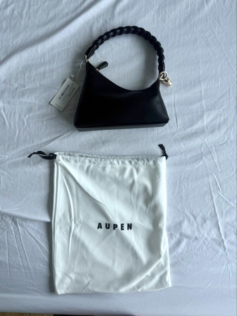 AUPEN Black Leather Shoulder Bag with Braided Handle (Category: Shoulder Bags) located in Quezon City. Submitted by jhosephllorente (Listing ID 1461452472, Image 3). Description: - Chic AUPEN black shoulder bag - Unique braided handle - Elegant gold charm detail - Comes with original dust bag - Versatile: Great for everyday use or a night out - Minimalist and stylish design.