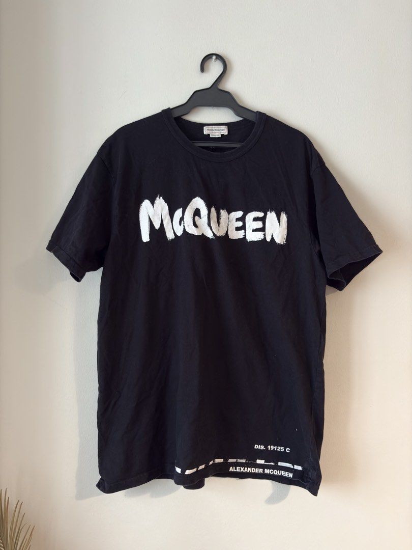 Authentic Alexander McQueen Graffiti Graphic Shirt (Category: Luxury Apparel) located in Mandaluyong City. Submitted by wear_your_style (Listing ID 1461384019, Image 1). Description: Made in Italy. Black na black pa po yan. Used a few times. Malambot. 100% cotton. Yung graffiti print nya ay parang painted talaga siya, like you can touch it. Size M on tag: approx 21 inches wide and 27 inches long. No issue: just maybe signs of wash and wear. Will 