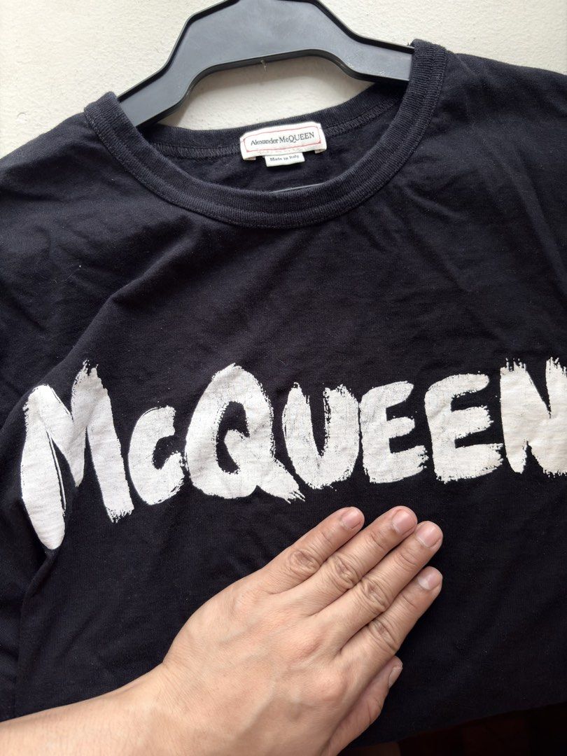 Authentic Alexander McQueen Graffiti Graphic Shirt (Category: Luxury Apparel) located in Mandaluyong City. Submitted by wear_your_style (Listing ID 1461384019, Image 2). Description: Made in Italy. Black na black pa po yan. Used a few times. Malambot. 100% cotton. Yung graffiti print nya ay parang painted talaga siya, like you can touch it. Size M on tag: approx 21 inches wide and 27 inches long. No issue: just maybe signs of wash and wear. Will 