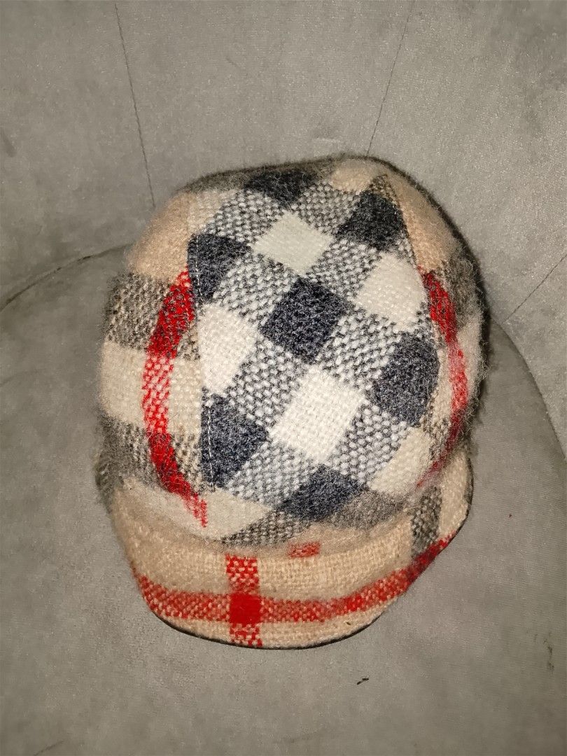 Authentic Burberry Bucket Hat Wool Leather Trim Mega Nova Check Beige Size Medium (Category: Hats & Beanies) located in Binangonan. Submitted by yuristalin888 (Listing ID 1461386812, Image 3). Description: Add a touch of iconic luxury to your casual wardrobe with this Burberry bucket hat. Featuring a classic plaid and checkered pattern in beige, white, charcoal, and red tones, this stylish hat is designed in a size medium. Inside, it is lined wit
