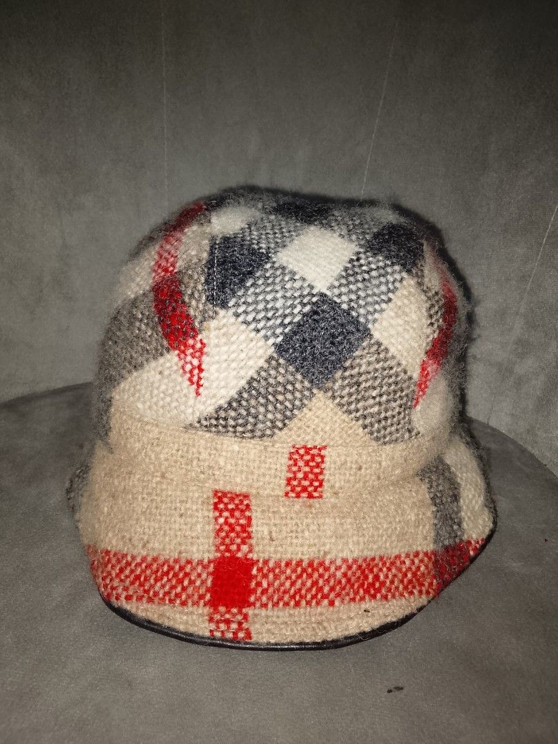 Authentic Burberry Bucket Hat Wool Leather Trim Mega Nova Check Beige Size Medium (Category: Hats & Beanies) located in Binangonan. Submitted by yuristalin888 (Listing ID 1461386812, Image 2). Description: Add a touch of iconic luxury to your casual wardrobe with this Burberry bucket hat. Featuring a classic plaid and checkered pattern in beige, white, charcoal, and red tones, this stylish hat is designed in a size medium. Inside, it is lined wit