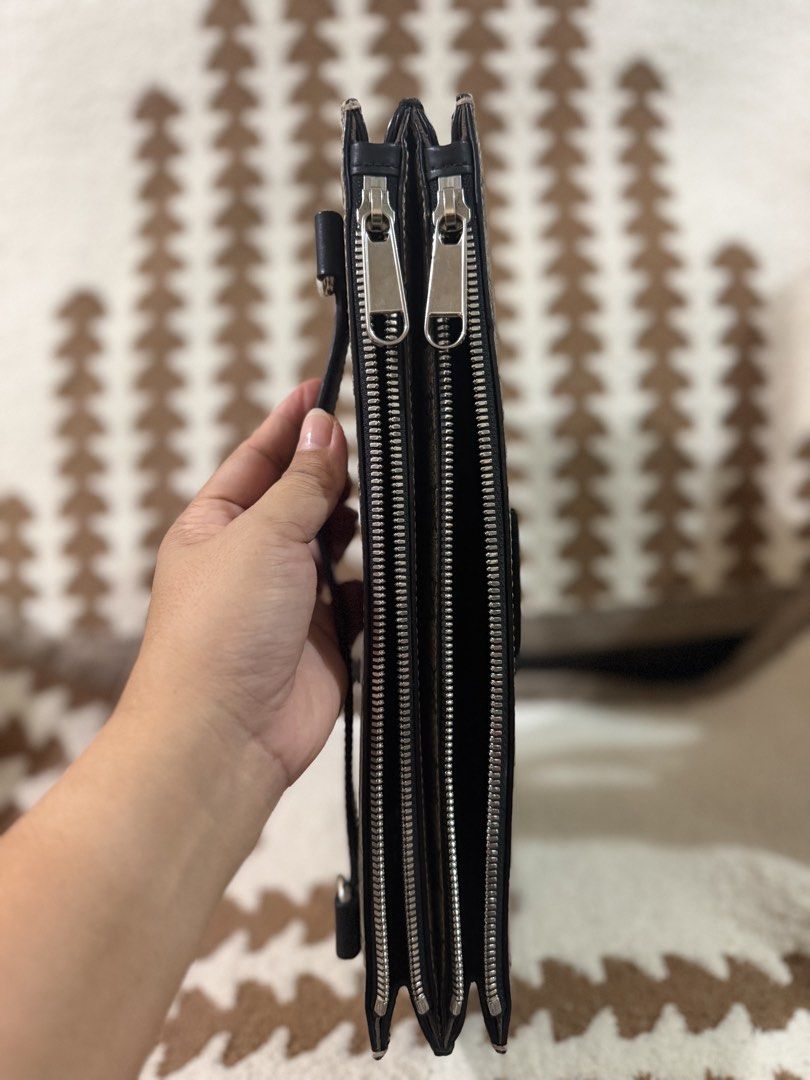 Authentic Gucci Multi Use Clutch Bag (Category: Clutches) located in Mandaluyong City. Submitted by topinvestment (Listing ID 1461476816, Image 3). Description: Product Details: Material: GG Monogram Leather Canvas double zip way Hardware: Silver-tone zipper closure Origin: Made in Italy Condition Notes: Overall Exterior: Clean canvas with no major marks. Zipper runs smoothly. Interior: Clean interior suede lining with minor signs of gentle use C