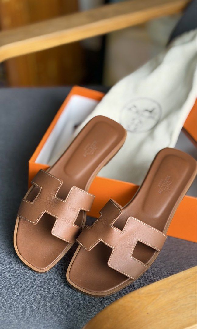 Authentic Hermès Oran Sandals with original box & dustbag (Category: Flats & Sandals) located in Quezon City. Submitted by mrzdc888 (Listing ID 1461398256, Image 3). Description: - Authentic Hermès Oran Sandals - Color: Gold - Size: EUR 36 (23.13cm or 9.1 inches) - Includes original box, original dust bag (2 pcs), original ribbon, and paper balls - Originally bought at Php55,000 - RFS: Size too small - Condition: 9.7/10 like new / Rarely used (ma