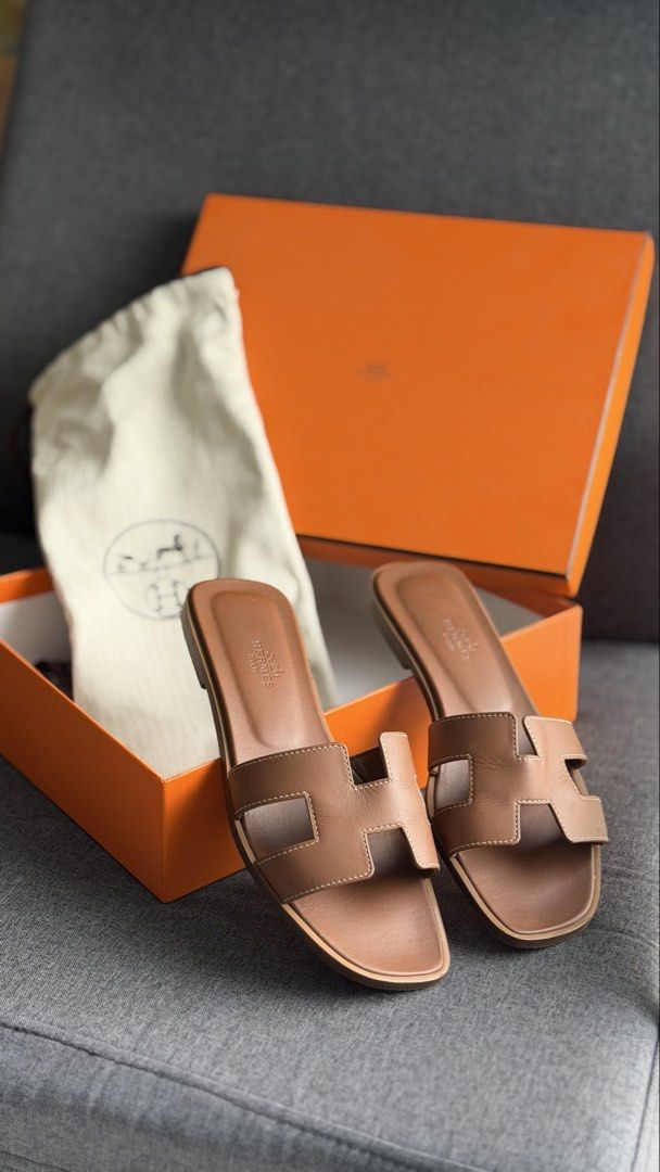 Authentic Hermès Oran Sandals with original box & dustbag (Category: Flats & Sandals) located in Quezon City. Submitted by mrzdc888 (Listing ID 1461398256, Image 2). Description: - Authentic Hermès Oran Sandals - Color: Gold - Size: EUR 36 (23.13cm or 9.1 inches) - Includes original box, original dust bag (2 pcs), original ribbon, and paper balls - Originally bought at Php55,000 - RFS: Size too small - Condition: 9.7/10 like new / Rarely used (ma